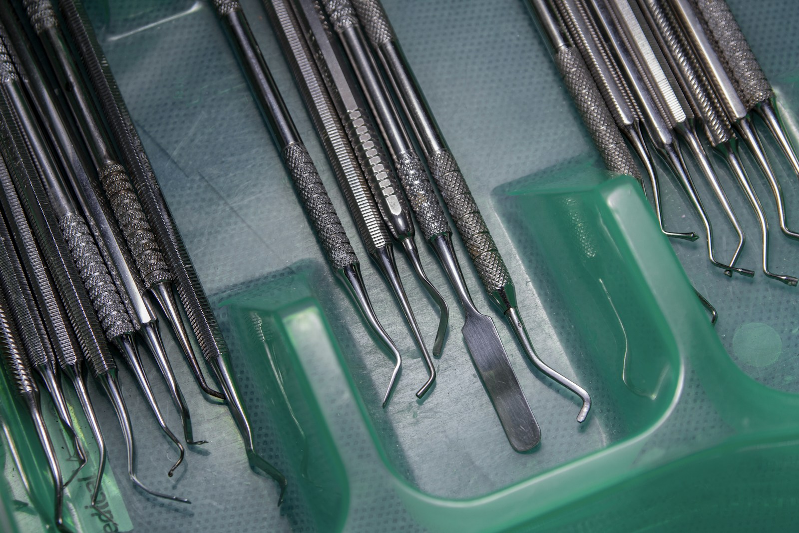 Stainless steel dental instruments arranged on a tray